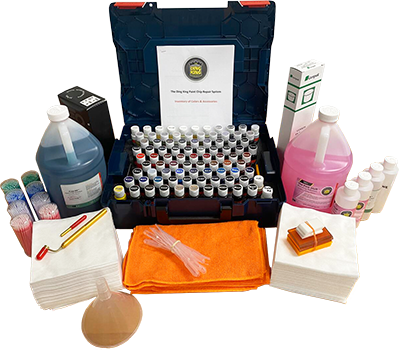 A PDR Training kit in California includes numerous small bottles, large jugs of blue and pink liquids, various tools, cloths, a funnel, and instructional manuals all organized neatly around a blue case.