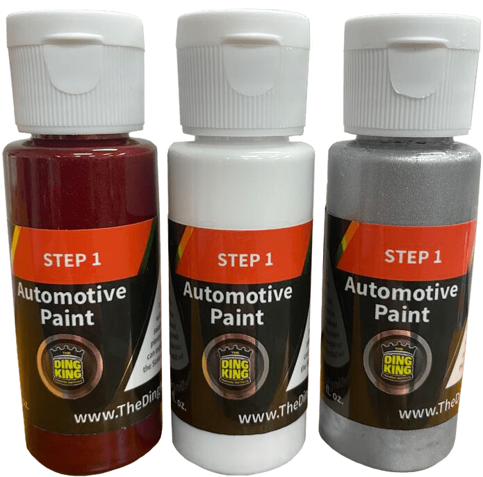 Three bottles of Step 1 automotive paint labeled "Ding King" in red, white, and silver colors, perfect for those undergoing PDR training in California.