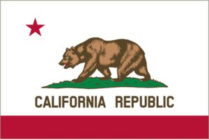 The image shows the California state flag featuring a grizzly bear walking on grass, a red star in the top left corner, and the words "California Republic" below the bear. This iconic symbol is often seen at PDR Training California facilities, highlighting their commitment to excellence.